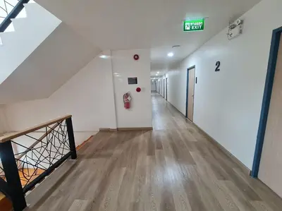 an empty hallway in a building with a fire hydrant at El Huq in Bangkok