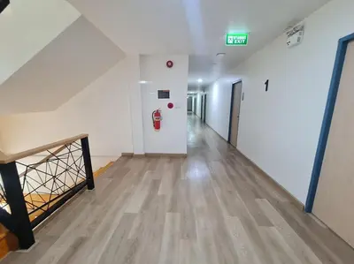 an empty hallway in a building with a fire hydrant at El Huq in Bangkok
