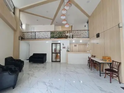 a large living room with a table and chairs at El Huq in Bangkok