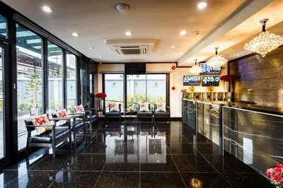 a restaurant with tables and chairs and windows at Lux Boutique Hotel in Nonthaburi