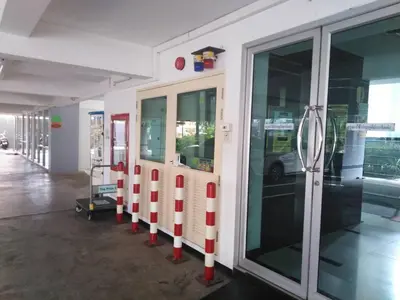 a gas station with red and white poles next to a door at THE PRIZE in Ban Yang