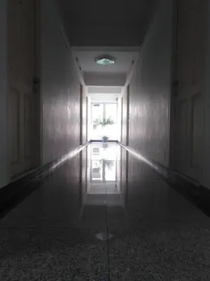 an empty room with a window and a reflection in the floor at THE PRIZE in Ban Yang
