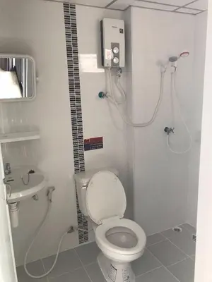 a bathroom with a toilet and a sink at THE PRIZE in Ban Yang