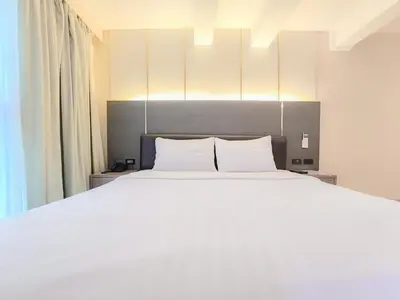 a bedroom with a large white bed with white pillows at Citin Sukhumvit 11 Nana Bangkok by Compass Hospitality in Bangkok