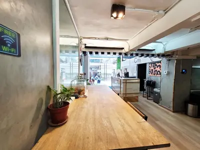 a hallway of a restaurant with a table in a room at Citin Sukhumvit 11 Nana Bangkok by Compass Hospitality in Bangkok