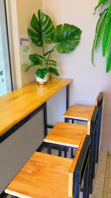 a plant in a pot sitting on top of two tables at Pranot Apartment & Spa in Nonthaburi