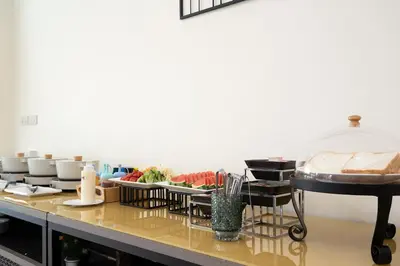 a buffet line with dishes and food on a table at Amanah Bangkok Hotel in Bangkok