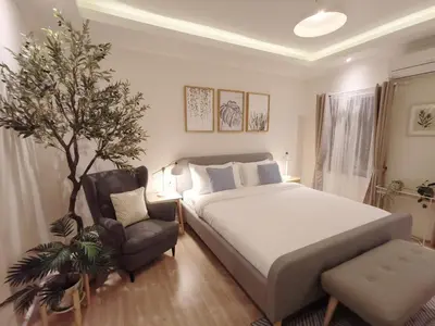 a bedroom with a bed and a chair at Double Bed Hotel in Bangkok