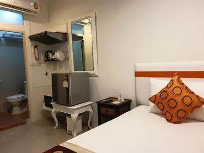 a bedroom with a bed and a mirror and a television at Arawana Residence Phromphong in Bangkok