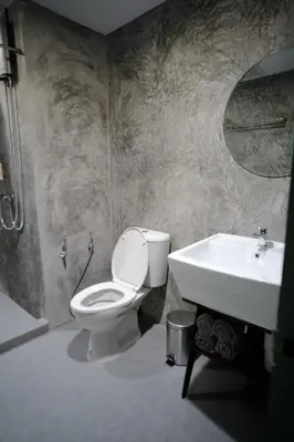 a bathroom with a toilet and a sink at Baan Khun Pra Duplex Rm3 Bangkok in Bangkok