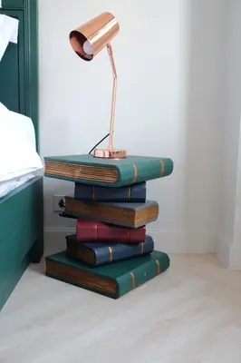 a stack of books with a lamp on top at Baan Khun Pra Duplex Rm3 Bangkok in Bangkok