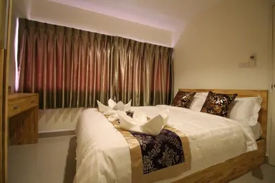 a bedroom with a large bed with a window at Lee Place Phatthanakan Condo in Bangkok