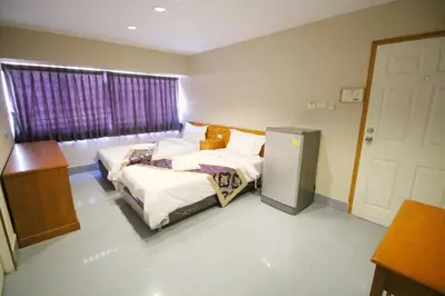 a hotel room with two beds and a window at Lee Place Phatthanakan Condo in Bangkok