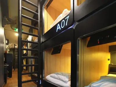 a group of bunk beds in a room at MyBed Ratchada in Bangkok
