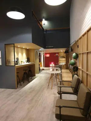 a lobby with chairs and a table in a room at MyBed Ratchada in Bangkok