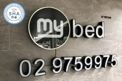 a sign on the side of a building with a mirror at MyBed Ratchada in Bangkok
