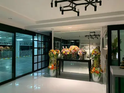 a flower shop with vases of flowers on a counter at Icare Residence & Hotel in Bangkok