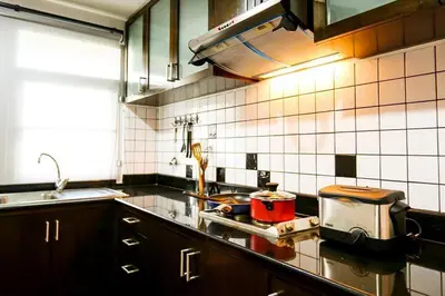 a kitchen with a counter top with a pot on the stove at Bellevue Boutique Bangkok in Amphoe Phra Khanong