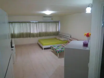 a living room with a bed and a couch at Airport Transfer Bangkok apartment in Thung Si Kan