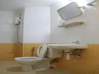 a bathroom with a toilet and a sink at Thailand Taxiapartment Hostel in Thung Si Kan
