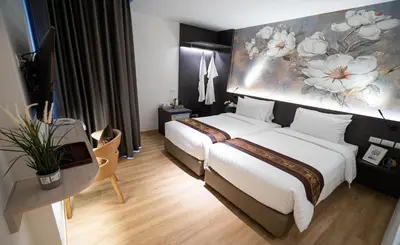 a hotel room with a bed and a painting on the wall at Pannarai Hotel Bangkok-Pra tunam in Bangkok