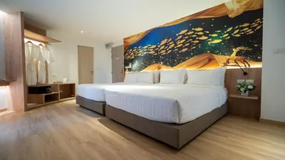 a bedroom with a large bed with a painting on the wall at Pannarai Hotel Bangkok-Pra tunam in Bangkok
