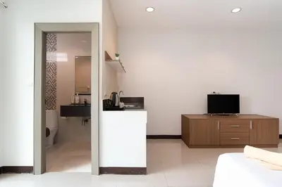 a white room with a kitchen and a living room at LeeNova Place in Lat Krabang