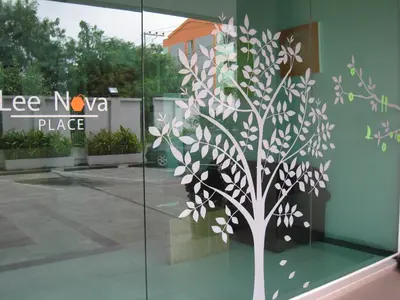 a tree mural on the side of a building at LeeNova Place in Lat Krabang