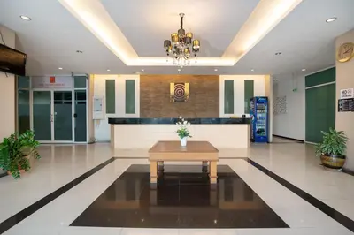 a lobby with a table in the middle of it at LeeNova Place in Lat Krabang