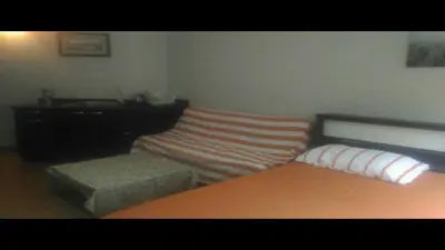 a bedroom with a bed and a bench and a sink at Airport Transfer Bangkok apartment in Thung Si Kan
