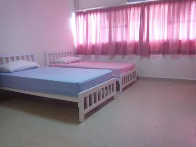 two beds in a room with pink curtains at Asia Don Mueang Bangkok Condominium in Thung Si Kan