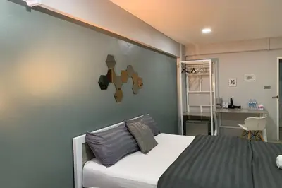 a bedroom with a bed and a desk in a room at 41BKK Hotel Rama9 in Bangkok