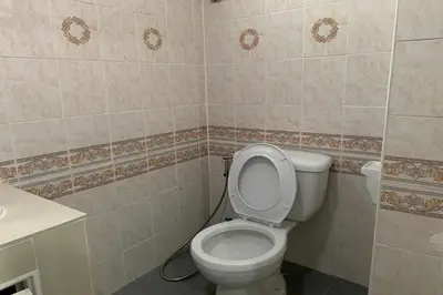 a bathroom with a toilet and a sink at 41BKK Hotel Rama9 in Bangkok