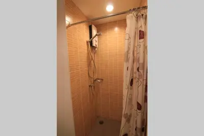 a bathroom with a shower with a shower curtain at Nice Condo near Ramkhamhaeng 60, Lam Sali MRT in Bangkok