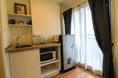 a kitchen with a small refrigerator and a window at Nice Condo near Ramkhamhaeng 60, Lam Sali MRT in Bangkok