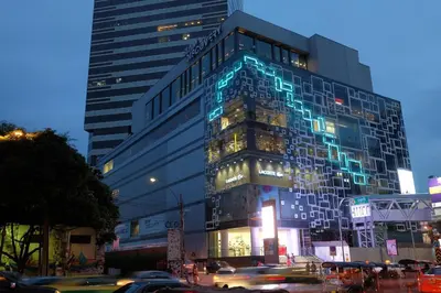 a tall building with blue lights on the side of it at Bangkok Hub Hostel in Bangkok