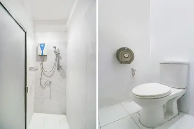 a white bathroom with a toilet and a shower at Bangkok Hub Hostel in Bangkok