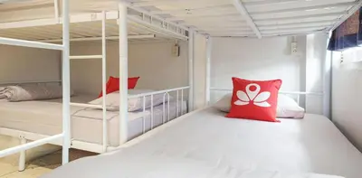 a room with two bunk beds with red pillows at Bangkok Hub Hostel in Bangkok