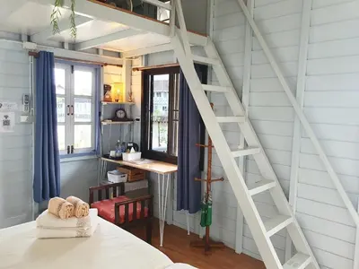 a room with a ladder next to a window at KINN Stay50 Bangkok in Bangkok Yai