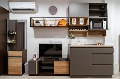 a living room with a desk and a tv at My space69 in Ban Pak Khlong Khwang
