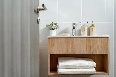a bathroom with a sink and a shelf with towels at My space69 in Ban Pak Khlong Khwang