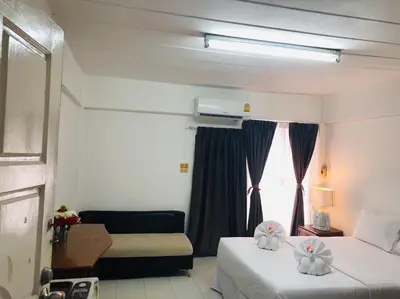 a hotel room with two beds and a window at I-Inn Hotel in Bangkok
