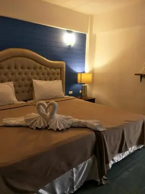 a bedroom with a bed with a heart on it at I-Inn Hotel in Bangkok