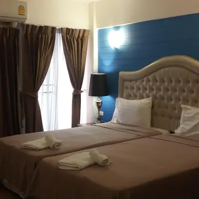a bedroom with a bed with two towels on it at I-Inn Hotel in Bangkok