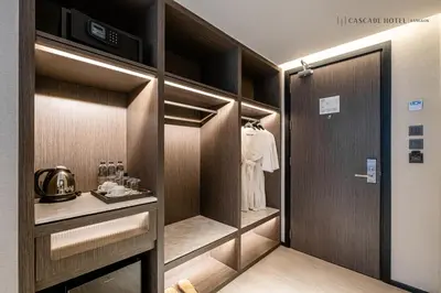 a walk in closet with a robe in it at Cascade Hotel Bangkok in Bangkok