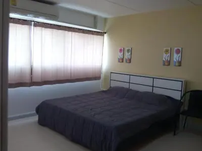 a bedroom with a large bed and a window at Asia Don Mueang Bangkok Condominium in Thung Si Kan