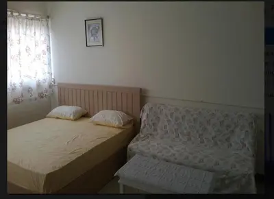 two beds in a small room with a window at Family Room Dmk Don mueang Airport 2 bedrooms in Ban Bang Phang