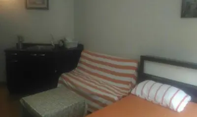 a bedroom with a bed and a dresser and a couch at Family Room Dmk Don mueang Airport 2 bedrooms in Ban Bang Phang