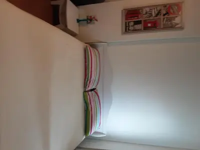 a room with a white wall with a window at T8 Guest House Don Mueang Challenger triple room in Ban Song Hong