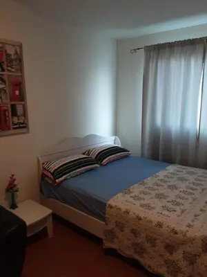 a small bedroom with a bed and a window at T8 Guest House Don Mueang Challenger triple room in Ban Song Hong